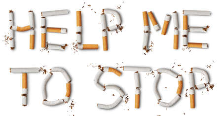 Text ''help me to stop'' made from broken cigarettesの写真素材
