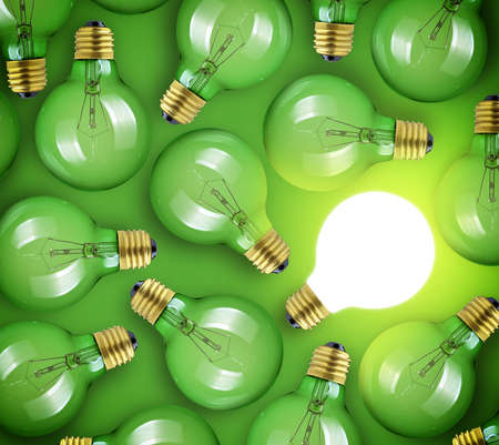 Concept for big idea. Glowing light bulb on green backgroundの写真素材