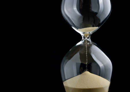 Close-up hourglass on black background
