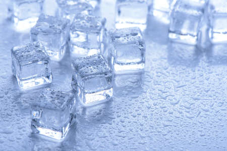 ice cubes with water drops on blue backgroundの写真素材