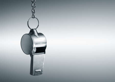 Hanging metal whistle closeup photoの写真素材