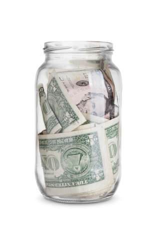 dollar bills in a glass jar isolated on white background