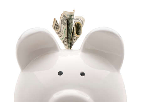 Close-up white piggy bank and US dollars. Isolated on white backgroundの写真素材