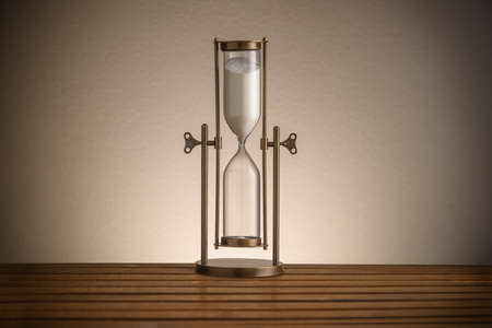 vintage hourglass on wooden tableの写真素材
