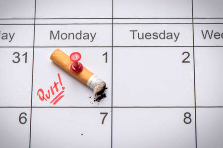 Cigarette on calendar. Time to quit smoking conceptの写真素材