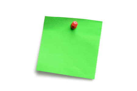 Green paper note pad attached with push pin isolated on white background