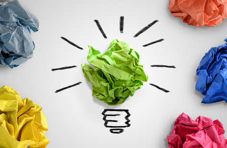 New idea concept. Colorful office paper balls and sketch of light bulbの写真素材