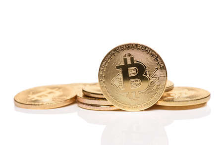 Macro shot of crypto currency gold Bitcoin coins. Isolated on white backgroundの写真素材