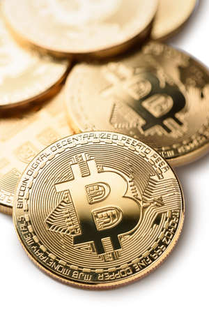 Macro shot of crypto currency gold Bitcoin coins. Isolated on white background