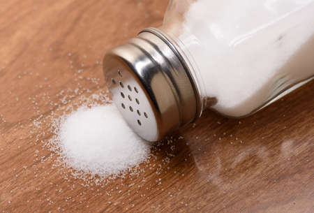 Salt shaker on wooden tableの写真素材