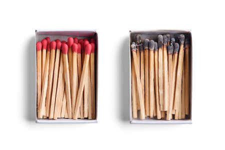 Top view of opened match boxes with burned matchsticks. Isolated on white backgroundの写真素材