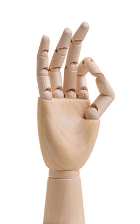 Wooden hand shows ok gesture. Isolated on white backgroundの写真素材
