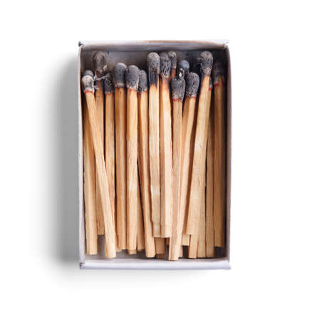 Top view of opened match boxes with burned matchsticks. Isolated on white backgroundの写真素材