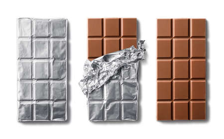 Top view of milk chocolate bar and chocolate bars in foil. Isolated on white backgroundの写真素材