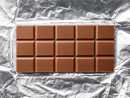 Top view of milk chocolate bar in open foilの写真素材