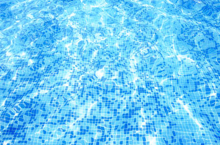 Water in swimming pool with sun reflection