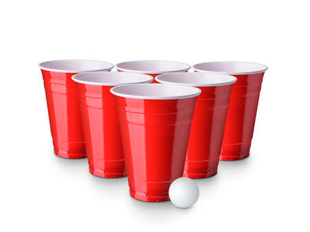 Red Beer Pong plastic cups with ball isolated on white background. Traditional drinking gameの写真素材