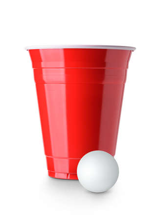 Beer pong. Red plastic cup and table tennis ball isolated on white backgroundの写真素材