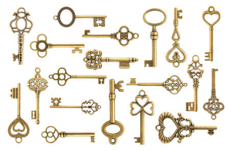 Set of vintage golden skeleton keys isolated on white backgroundの写真素材