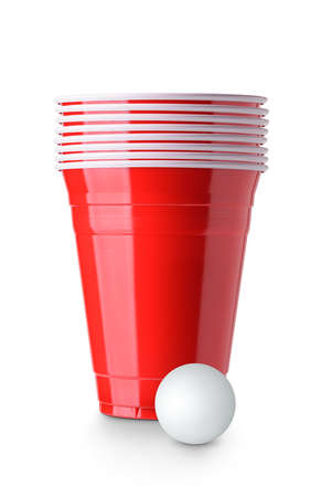 Beer pong. Red plastic cups and table tennis ball isolated on white backgroundの写真素材