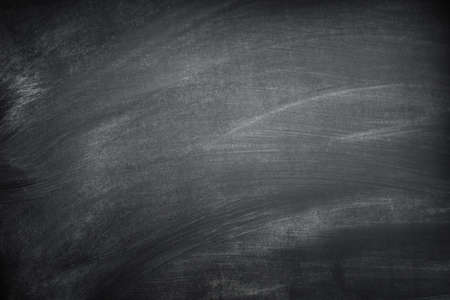 Blank black chalkboard with chalk tracesの写真素材