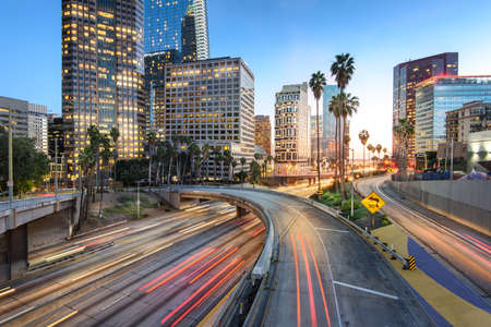 Downtown Los Angeles at sunset with car traffic light trailsの写真素材