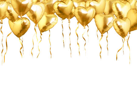 Flying of golden heart shaped air balloons. Isolated on white backgroundの写真素材