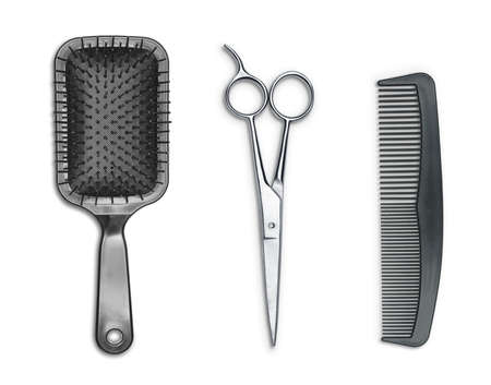 Hair cutting shears, hairbrush and comb isolated on whiteの写真素材