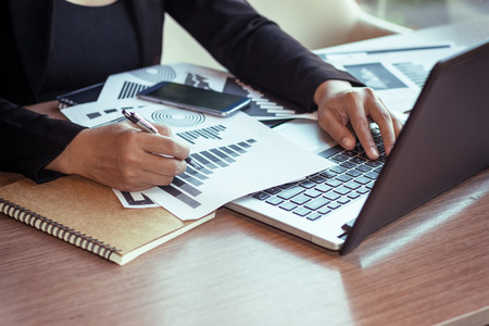 Close Up of woman hands using mobile phone and laptop computer with blank copy space screen for your advertising text message or content business in the Vintage effect.の写真素材