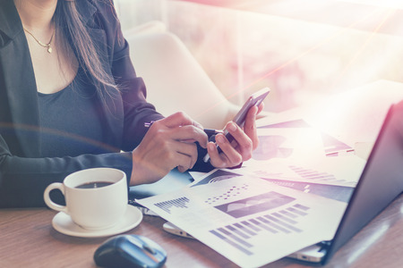 Close Up of woman hands using mobile phone and laptop computer with blank copy space screen for your advertising text message or content business in the Vintage effect.の写真素材