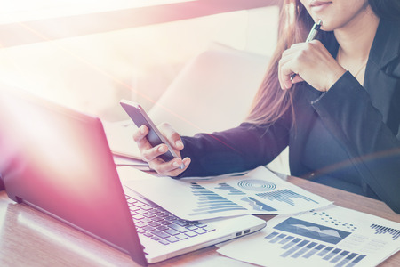 Close Up of woman hands using mobile phone and laptop computer with blank copy space screen for your advertising text message or content business in the Vintage effect.の写真素材