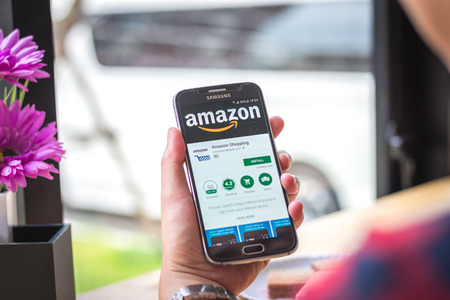 Chiang Mai, Thailand - September 12, 2017: Samsung Galaxy S6 smartphone launches amazon shopping application on the desk screen at the coffee shop.のeditorial素材