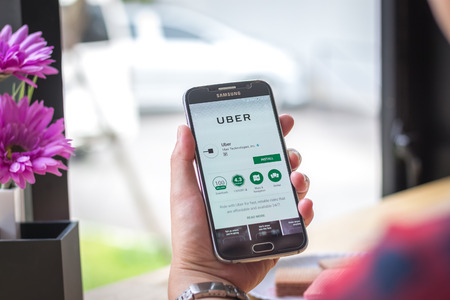 Chiang Mai, Thailand - September 12, 2017: Samsung Galaxy S6 smartphone launches uber driver application on the desk screen at the coffee shop.のeditorial素材