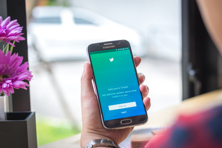 Chiang Mai, Thailand - September 12, 2017: Samsung Galaxy S6 smartphone launches twitter application on the desk screen at the coffee shop.のeditorial素材
