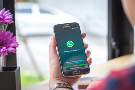 Chiang Mai, Thailand - September 12, 2017: Samsung Galaxy S6 smartphone launches whatsapp application on the desk screen at the coffee shop.のeditorial素材