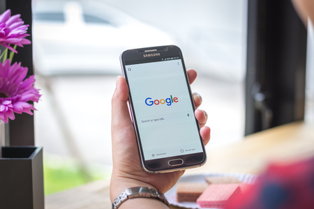 Chiang Mai, Thailand - September 12, 2017: Samsung Galaxy S6 smartphone launches google search application on the desk screen at the coffee shop.のeditorial素材