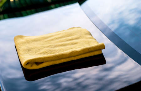 cleaning her new car using microfiber cloth