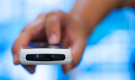 Woman hands with remote controlの写真素材