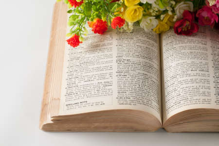 book and flowers isolated on whiteの写真素材