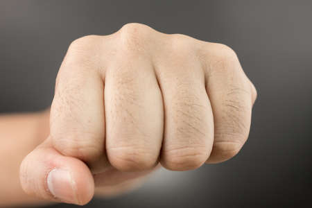 Power concept. Man Punch fist on black backgroundの写真素材