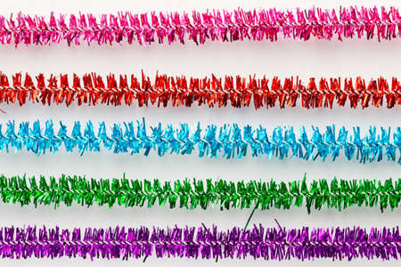 The colorful multicolor of tinsel for a background.multicolored New Year's tinsel isolated on white...