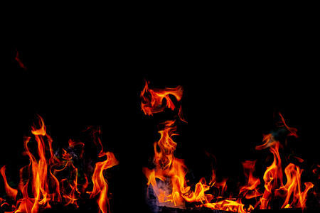 Fire flames on Abstract black background, Burning red hot sparks rise from large fire in, Fiery orange glowingの写真素材