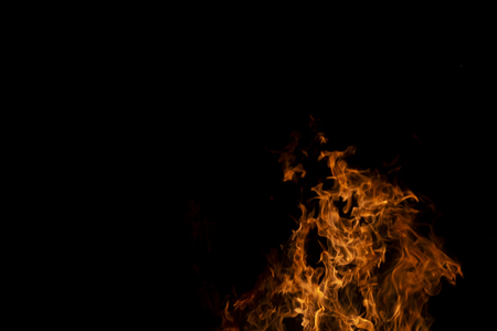 Fire flames on Abstract art black background, Burning red hot sparks rise from large, Fiery orange glowingの写真素材