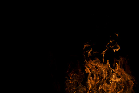 Fire flames on Abstract art black background, Burning red hot sparks rise from large, Fiery orange...