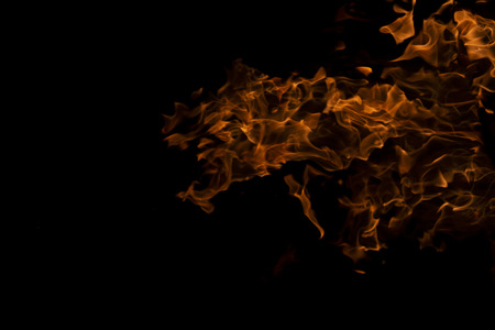 Fire flames on Abstract art black background, Burning red hot sparks rise from large, Fiery orange glowingの写真素材