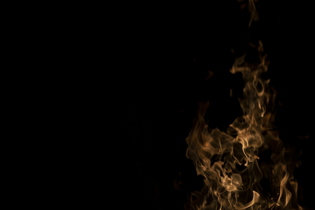 Fire flames on Abstract art black background, Burning red hot sparks rise from large, Fiery orange...
