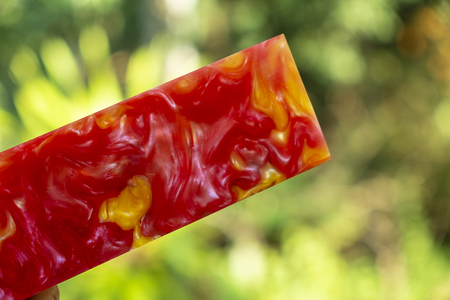 casting epoxy resin Stabilizing Afzelia burl exotic wood, close up red yellow Abstract art background texture, hybrid for blanksの写真素材