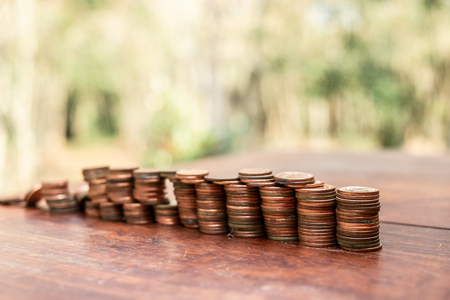 Thai bath coin 25 satang lots on wooden table with blurred background, Money of Thailand, Investment...