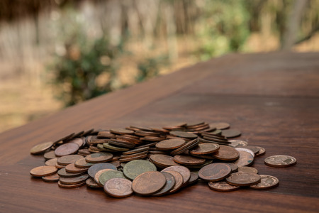 Thai bath coin 25 satang lots on wooden table with blurred background, Money of Thailand, Investment and saving concept, Money stack for business planning investmentの写真素材