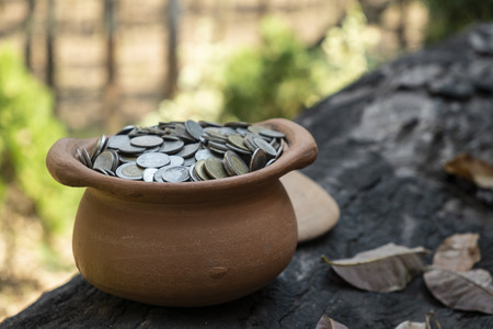 Coins in jar on wooden with blurred background, Money stack for business planning investment and saving conceptの写真素材
